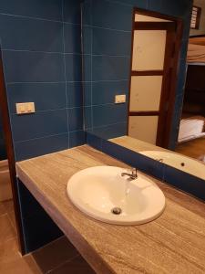 a bathroom counter with a sink and a mirror at Slow Life Sabaidee Pai in Pai
