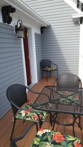 dwa krzesła i stół na ganku w obiekcie Davis Square Inn w mieście Somerville