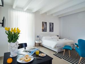 a bedroom with a bed and a table with food on it at Re Federico Boutique Hotel in Syracuse