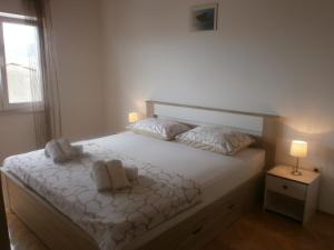 Postel nebo postele na pokoji v ubytování Apartmani Ljubica