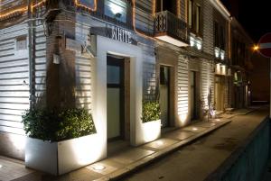 un edificio con una porta su una strada di notte di White albergo diffuso Ristorante & SPA a Foggia