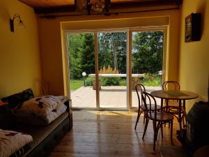 a room with a bed and a table and a glass door at Ranczo u Nikodema in Silice