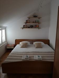 a bedroom with a bed with two towels on it at Apartment Sea San in Makarska