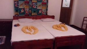 two pretzels on a bed in a room at Prasad Suomi Villa in Matara +83 photos