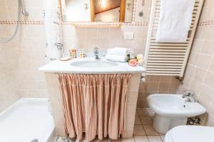 a bathroom with a sink and a toilet at Cavourotto Terrace by Mmega in Florence +10 photos