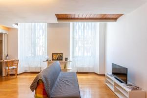 a living room with a couch and a tv at Cavourotto Terrace by Mmega in Florence