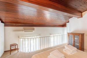 a bedroom with a bed and a wooden ceiling at Cavourotto Terrace by Mmega in Florence