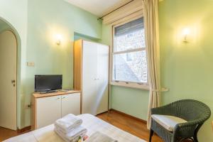 Televízia a/alebo spoločenská miestnosť v ubytovaní Tiny Ponte Vecchio by Mmega