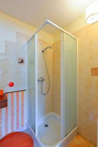 a shower with a glass door in a bathroom at Appartement Kermadoué 1 in Trégunc