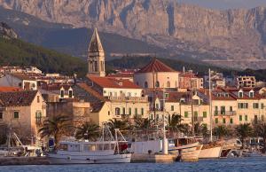 a group of boats docked in the water near a city at Apartment Markus in Makarska