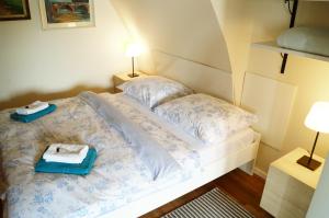 a bedroom with a bed with two towels on it at Apartmány u komína in Terezín