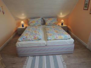 a bed in a small room with two night stands at Goden Wind 4 in Westerdeichstrich