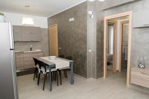 a kitchen with a table and a dining room at Casa Vacanze Fontana in San Vito lo Capo +74 photos