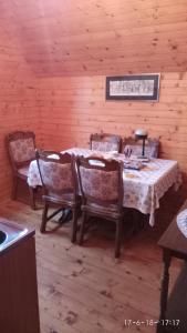 a dining room with a table and chairs in a cabin at Apartments Vila Marija in Žabljak