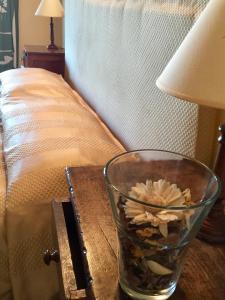 a glass vase with a flower in it on a table at Il Girasole Terzuolo in Manciano +59 photos