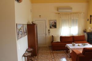 a living room with a couch and a table at Village Guesthouse in Keramoti