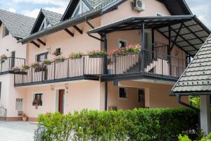 a building with flower boxes on balconies at Luxury apartment Karolina in Bled
