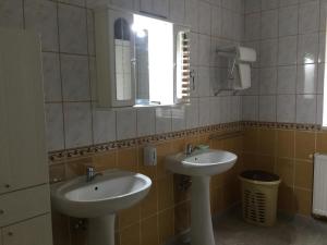 a bathroom with two sinks and a mirror at Casa Bella Turda in Turda +42 photos