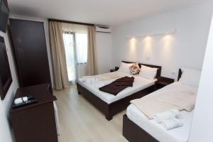 Un pat sau paturi într-o cameră la Vila Sandra
