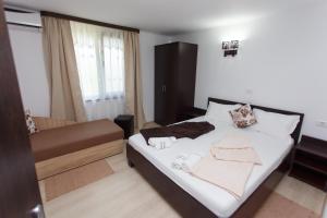 Postel nebo postele na pokoji v ubytování Vila Sandra