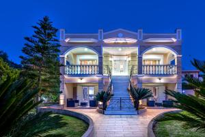 a large house with a staircase in front of it at Erato Apartment in Tsilivi