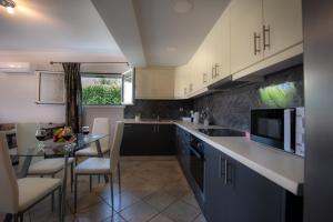 a kitchen with a table and a counter top at Erato Apartment in Tsilivi +9 photos
