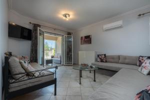 a living room with a bed and a couch at Erato Apartment in Tsilivi
