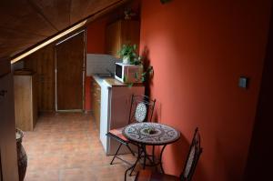 a small kitchen with a small table and a refrigerator at Guest House Haklův Mlýn in Hrabětice