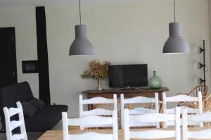 a living room with a table and chairs at Casa Rural ABARAXKA- Espectaculares Vistas a las Verdes Montañas a sólo 20 minutos de la Playa" in Azcoitia