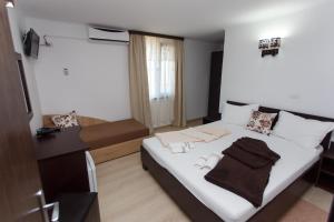 Postel nebo postele na pokoji v ubytování Vila Sandra