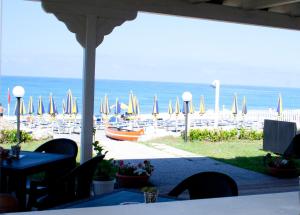 a view of a beach with chairs and umbrellas at Hotel Felix in Scalea