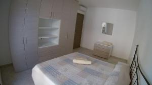 a white bedroom with a bed and a cabinet at Matilde Apartment Pula in Pula +20 photos