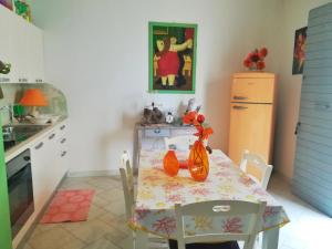 a kitchen with a table with a vase on it at Le Terrazze in Otranto
