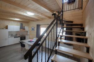 a kitchen and dining room with a staircase in a cabin at 1861 Blejka apartments Bled in Bled