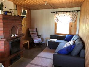 a living room with a couch and a fireplace at ILO107 in Huhus