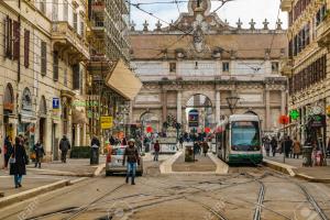 a city street with a tram in front of a building at Romantic Flat near Metro Flaminio in Rome