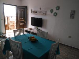 a dining room table with a bowl of fruit on it at Casa Corina. Primera línea de mar in Punta Mujeres