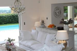a living room with a white couch and a table at Villa Le B in Cogolin