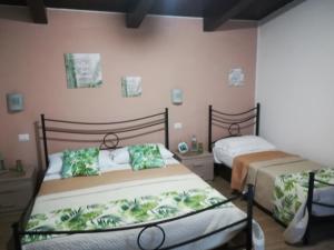 a bedroom with two beds in a room at Agriturismo Santa Maria in Marta
