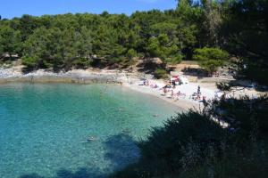 a group of people in the water at a beach at Apartments Nicole in Pula