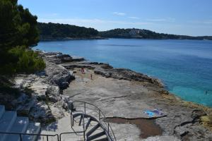 a view of a beach with people on the water at Apartments Nicole in Pula