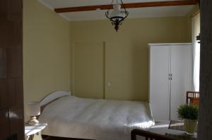 a bedroom with a bed and a white cabinet at Papli Villade Apartment in Pärnu