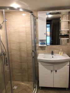 ein Badezimmer mit Waschbecken und Dusche in der Unterkunft Villa Victoria - a luxury appartment with icredible Seaview in Sozopol