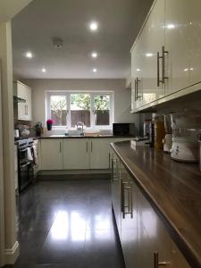 a large kitchen with a large wooden counter top at Sage House in Northampton