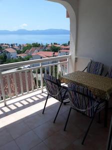 a table and chairs on a balcony with a view at Apartments Pehar in Zaostrog