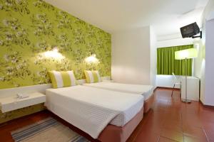 Posteľ alebo postele v izbe v ubytovaní Hotel Praia Dourada