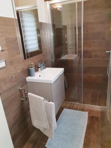 a bathroom with a sink and a shower at Studio App Aqua in Funtana