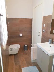 a bathroom with a toilet and a sink at Studio App Aqua in Funtana