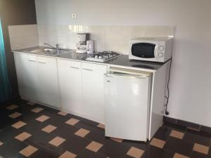Virtuvė arba virtuvėlė apgyvendinimo įstaigoje Residence Jardin Tropical