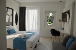 a bedroom with two beds and a desk and a chair at Centurio luxury rooms in Tropea +47 photos